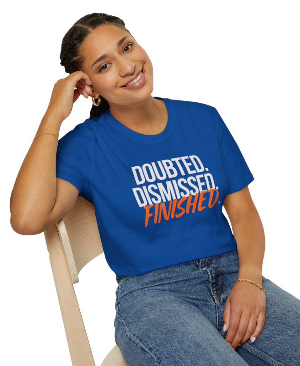 Person wearing a blue t-shirt with motivational text, sitting on a chair.